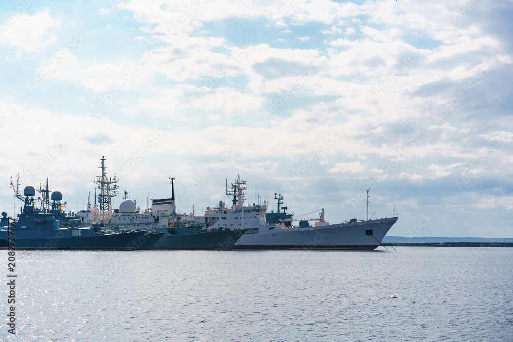Fototapeta premium Ships of russian navy are on dock on water against background of sky