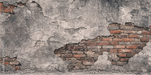 Cuadro en lienzo Old plaster wall texture with cracked deteriorating surface exposing red bricks