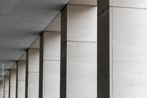 Abstract architectural background with a rhythmic perspective of modern concrete columns