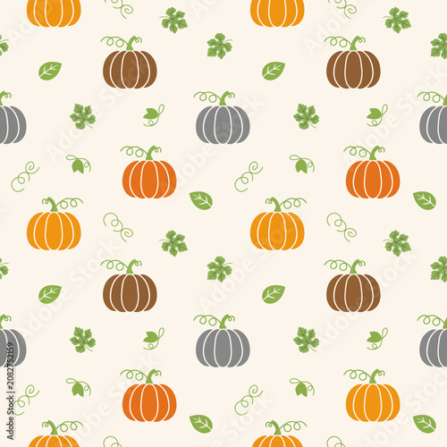 pumpkins and leaves on beige background