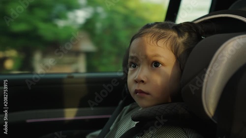preschool child girl sitting in car seat with sunlight, safety baby chair travelling