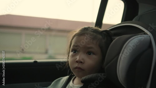 preschool child girl sitting in car seat with sunlight, safety baby chair travelling