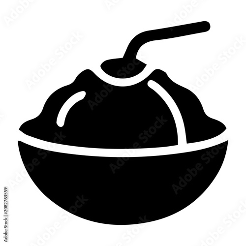 Traditional Asian style shaved ice or coconut bowl dessert topped with a straw.