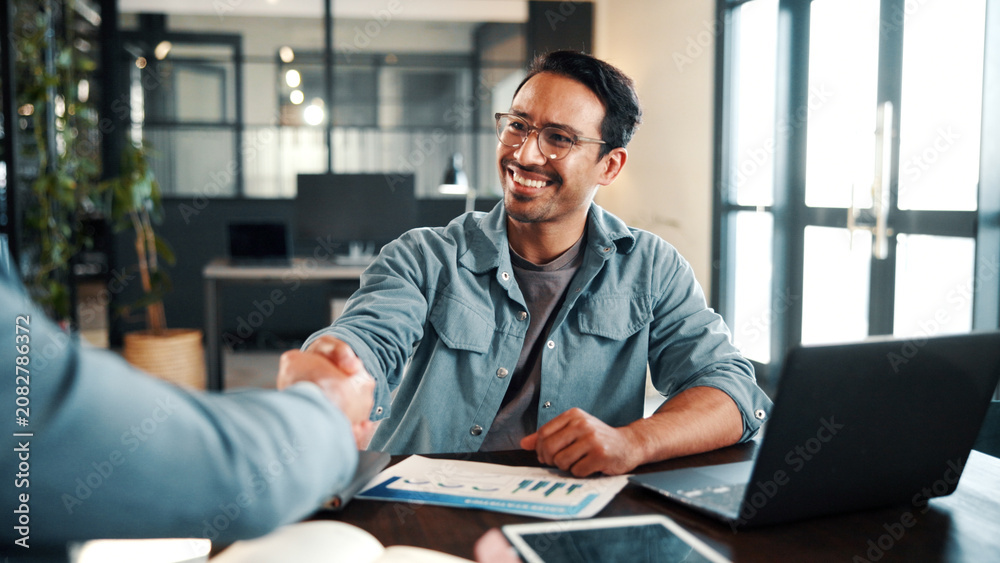 Obraz premium Handshake, meeting and business people with document for review, planning and graphs. Office, shaking hands and man with laptop for welcome, b2b budget and collaboration for proposal or negotiation