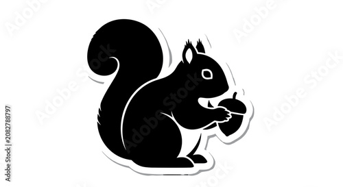 Black Squirrel Silhouette Holding Nut.