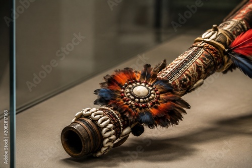 Canvastavla Ornate ceremonial blowpipe with feathers and shells, museum cultural display
