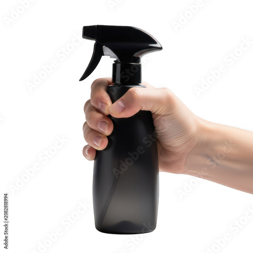 A hand holding a black plastic spray bottle for cleaning surfaces