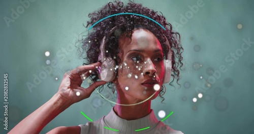 Turning model in ribbed top, white headphones adjusting cups in studio as ring appearing for demo