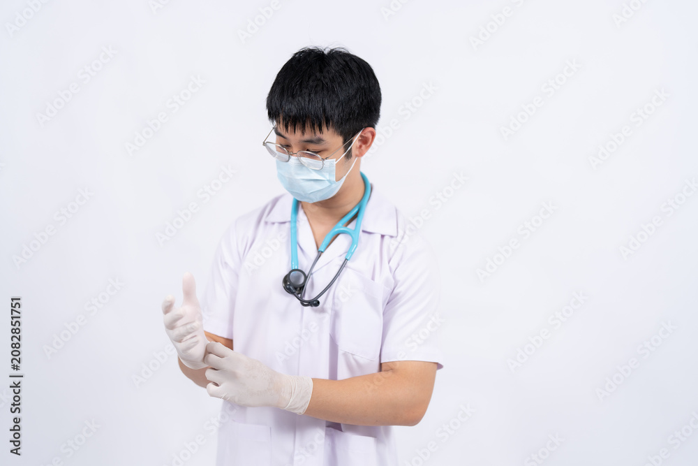 Fototapeta premium An Asian physician stands confidently in a clean clinical setting, representing reliable medical care, hospital professionalism, and preventive healthcare services.