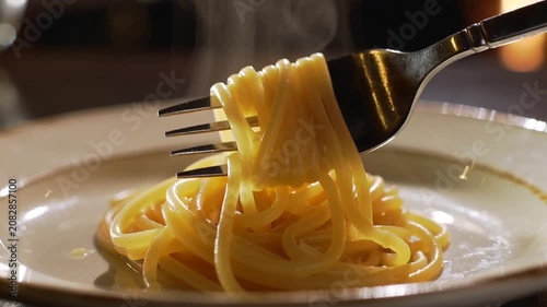Twirling delicious spaghetti pasta onto a fork