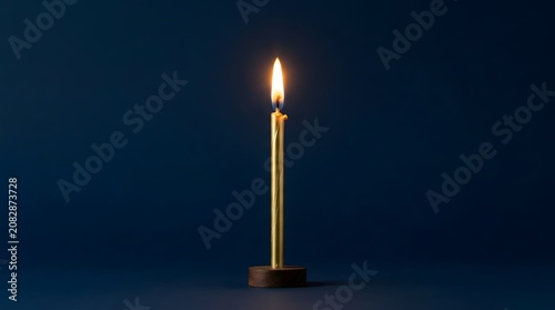 Single lit candle on dark blue background in minimalist style