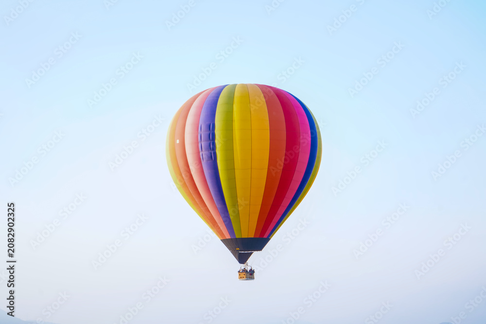 Fototapeta premium Colorful hot air balloon flying in a clear blue sky