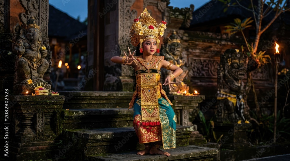 Fototapeta premium Balinese child dancer performs traditional ritual at ancient temple at night.
