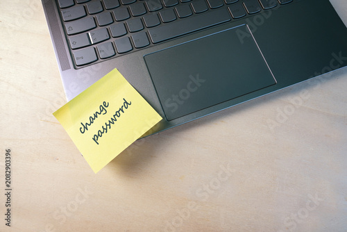 Sticky note with text change password on a laptop, protection of sensitive data from access by others, security concept, copy space