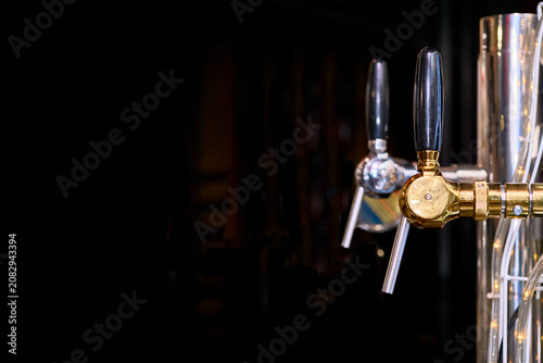 Cuadro en lienzo Beer drink faucets dispensers on black in bar