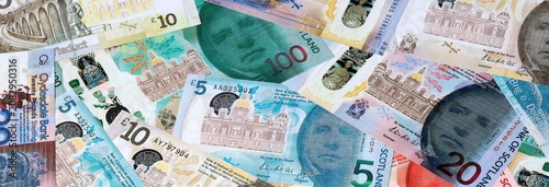 Scottish pound money banknotes bunch on table. Scotland bills of GBP currency close up