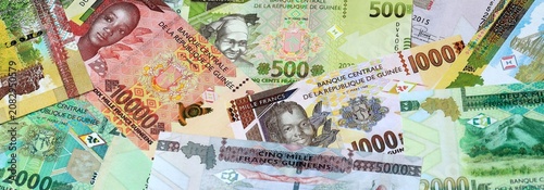 Bild auf Leinwand Guinean franc money banknotes bunch on table