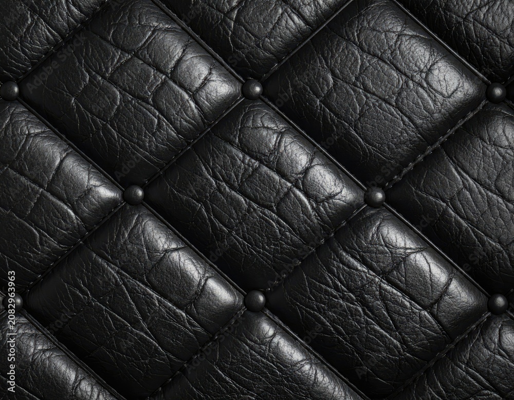 Obraz premium Close-up of diamond-tufted black textured material with decorative studs