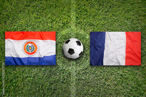 Paraguay vs. France flags on a soccer field