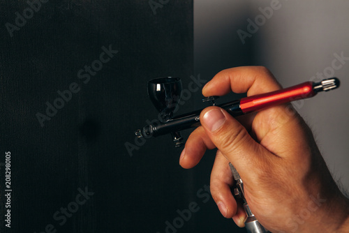 a man painting with an airbrush