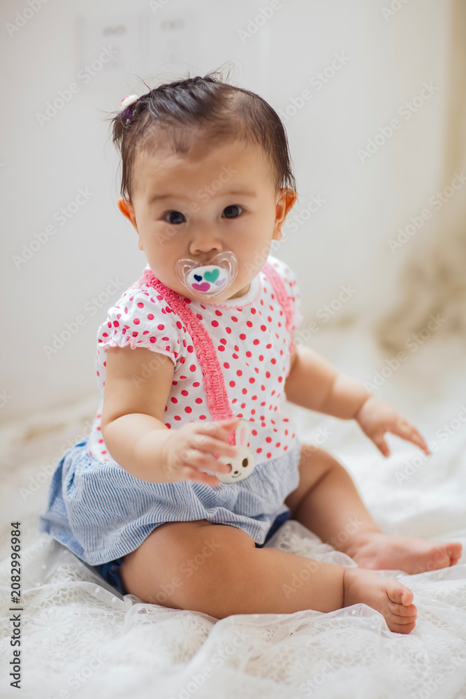 Fototapeta premium A cute 1-year-old Asian girl indoors
