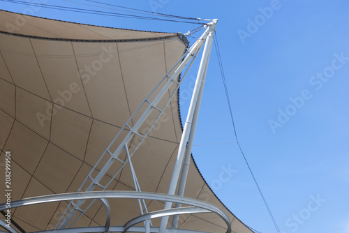 Modern architectural tent roof against vibrant blue sky