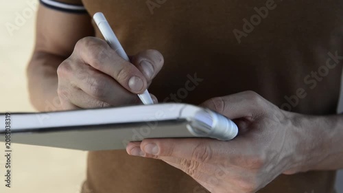Close up of man hands writing and taking notes in paper notebook.