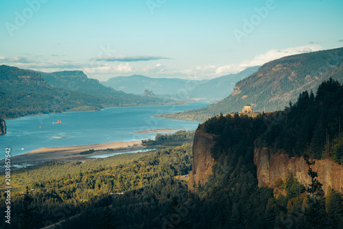 Columbia River Gorge with historic Vista House in golden evening light at sunset, Oregon, Pacific Northwest, USA