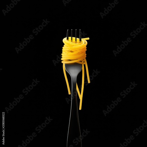 Twisted Spaghetti Pasta on Elegant Metal Fork with Rustic Gourmet Culinary Background Composition