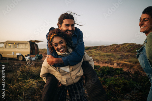 Friends playing and having fun during a camping trip