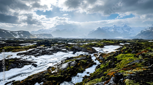 Rugged rocky shore with flowing water and green moss