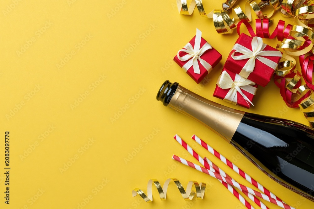 Fototapeta premium The Champagne Bottle centerpiece with Gift Boxes and Festive Ribbons