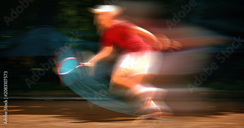 Bild auf Leinwand Tennis player sprinting across court with motion blur during fast paced rally