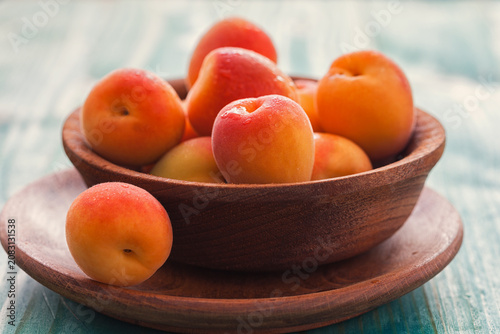 Fresh ripe apricots on the blue wooden background