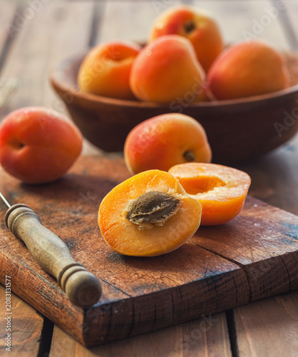 Fresh ripe apricots on the wooden background