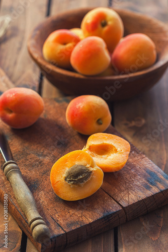 Fresh ripe apricots on the wooden background