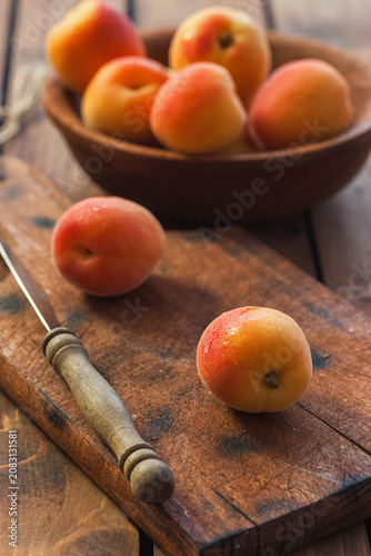 Fresh ripe apricots on the wooden background