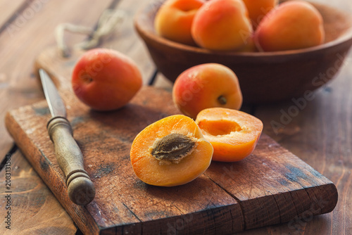 Fresh ripe apricots on the wooden background