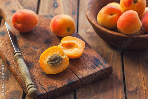 Fresh ripe apricots on the wooden background