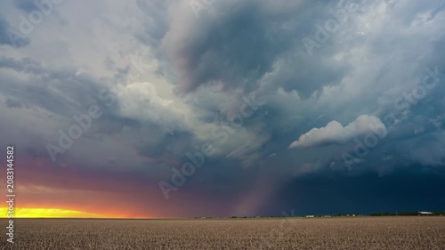 Colorful storm clouds at sunset moving across beautiful sky