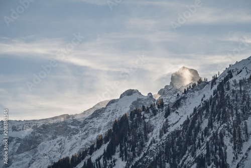 Snow-Covered Holzgauer Wetterspitze Mountain Peak in the Lechtal Alps, Dramatic Alpine Landscape with Blowing Snow and Clouds in Tyrol Austria