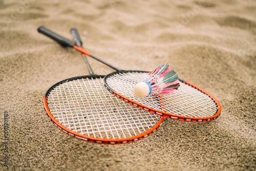 Tableau sur toile Badminton Shuttlecock and Racket on Sandy Beach