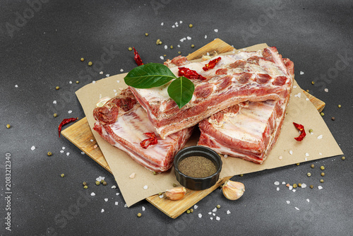 Raw marinated pork ribs prepared for BBQ picnic with spices, garlic and bay leaves
