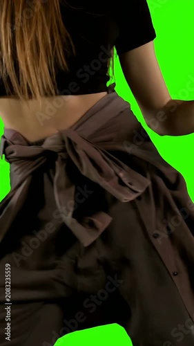 Vertical video: Starting dancer moving right, hip roll, arm reaching, jacket flaring on greenscreen