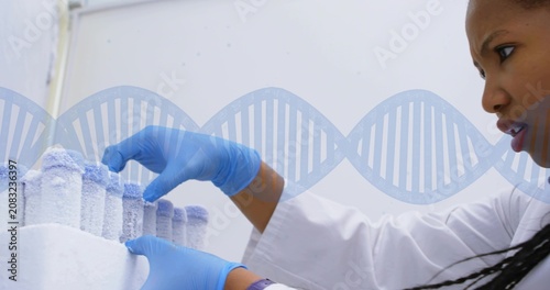 Obraz na plátne After rack removal from freezer tech lifting frozen vial inspecting under DNA he