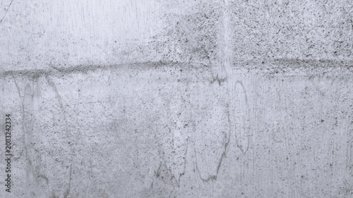 Obraz na płótnie Monochrome stained plaster wall with horizontal grime band, vertical drip marks, and worn construction surface detail