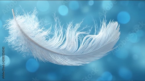 Close up of a single white feather against a blurred blue background