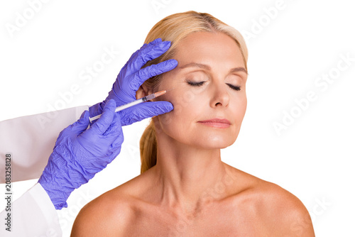 Obraz na plátně Portrait of middle aged woman have skin tightening dermatology injection doctor