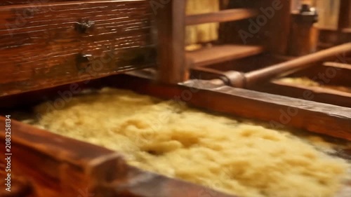Close up of a wooden structure with foamy liquid possibly for industrial use