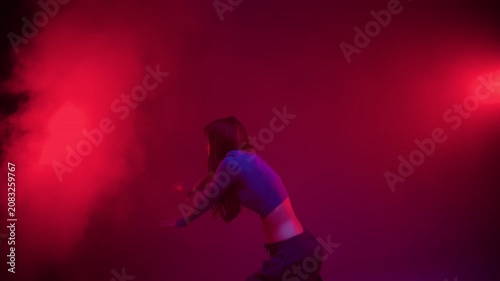 Contemporary dance expressive pose in red stage light
